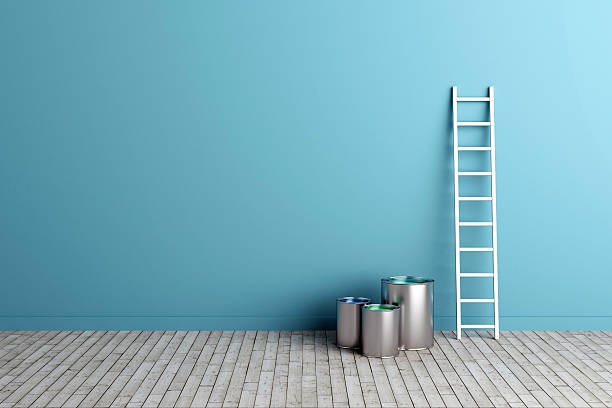 ladder and paint buckets by the wall