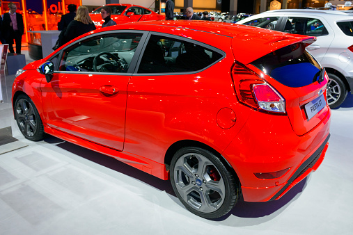 Brussels, Belgium - January 15, 2015: Ford Fiesta ST hatchback car on display during the 2015 Brussels motor show. People in the background are looking at the cars.