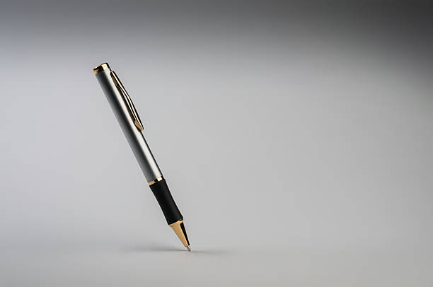 istock Isolated pen balanced on its tip on a gray background 468690217