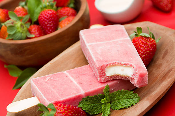 istock Frozen strawberry popsicles amidst fresh strawberries 468691356