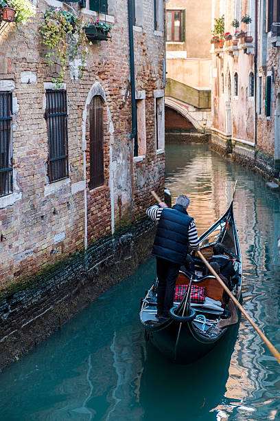 istock Venice canal with gondola, Italy 468691660