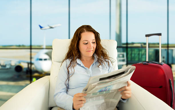 vip zone aiport woman commenting economy news in vip zone aiport newspaper airport reading business person stock pictures, royalty-free photos & images