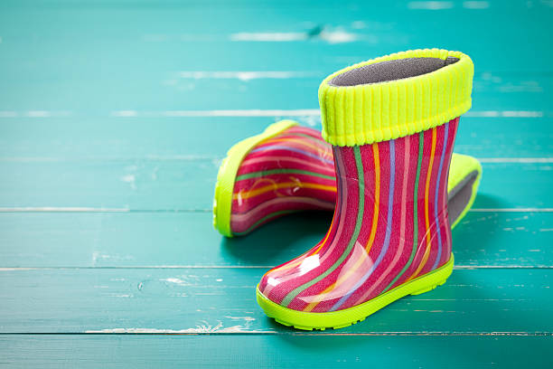 istock Baby rubber boots on turquoise table 468697330