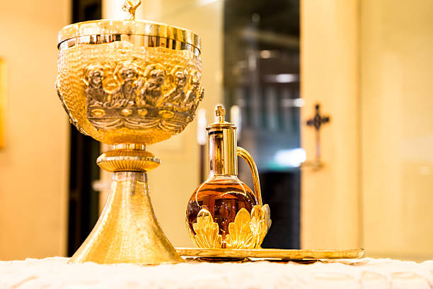 istock Catholics bread and wine in chalice with crucifix in background 468697560