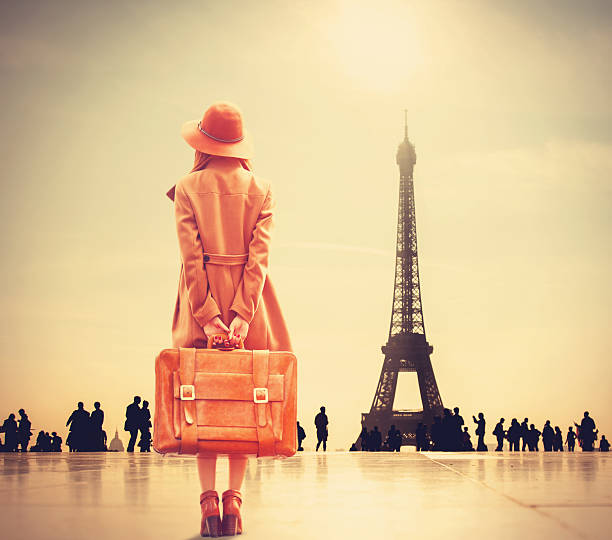 Redhead girl with suitcase Redhead girl with suitcase on Eiffel tower background paris fashion stock pictures, royalty-free photos & images