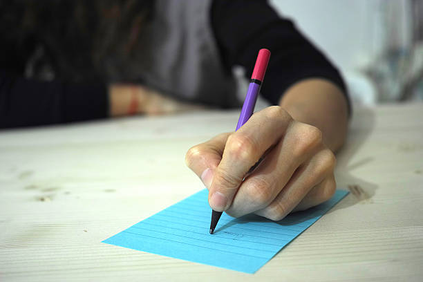 istock Woman Hand Taking Note With a Purple Pencil 468704282