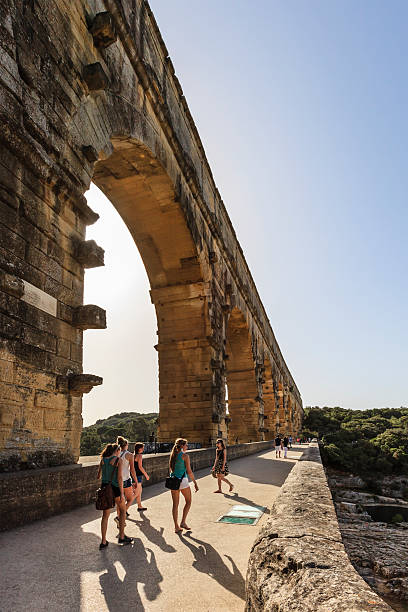Vers-Pont-du-Gard, France - June 9, 2014: People strolling on the Pont du Gard, the Roman bridge at three levels built around 17 Ac.