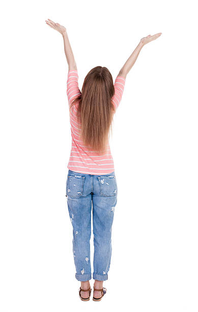 istock Back view Beautiful woman in jeans looking wall and Holds 468706008