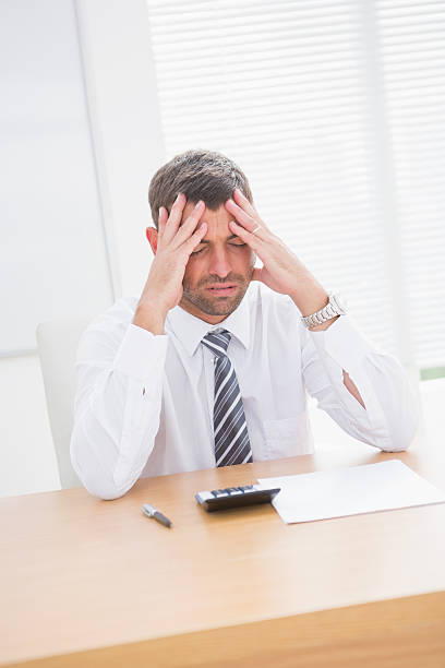 istock Stressed businessman with head in hands 468709964