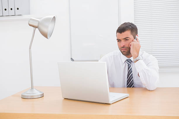 istock Businessman on the phone using his laptop at desk 468710100