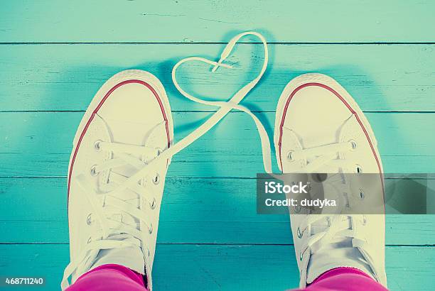 Sneakers With Heart On Blue Wood Background Filtered Image Stock Photo - Download Image Now