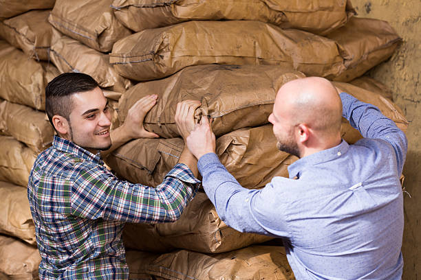 istock Workers carrying bags of cement 468711472