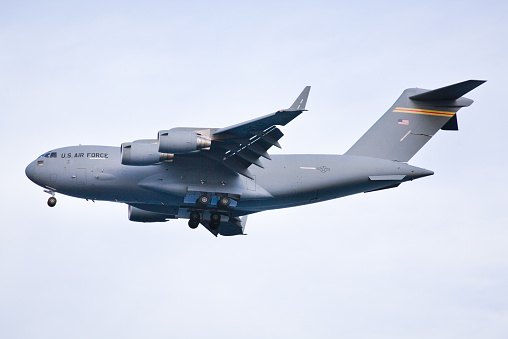 Profile side view of the military cargo transport plane C-17 in flight.
