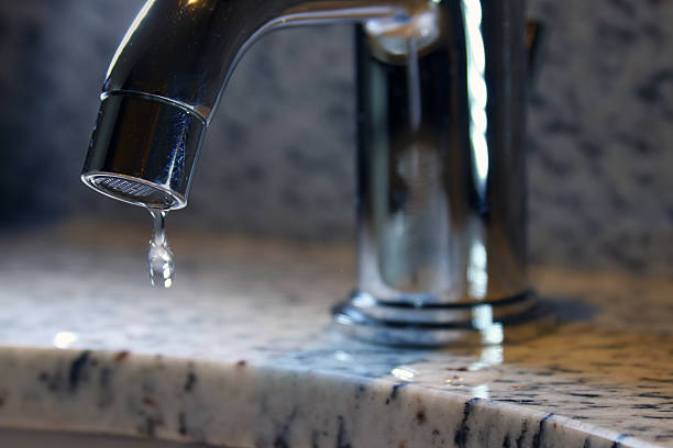 istock Bathroom sink faucet dripping 468713495