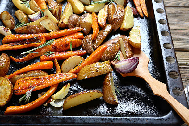 istock Potatoes with carrots, onions on a baking tray 468713830
