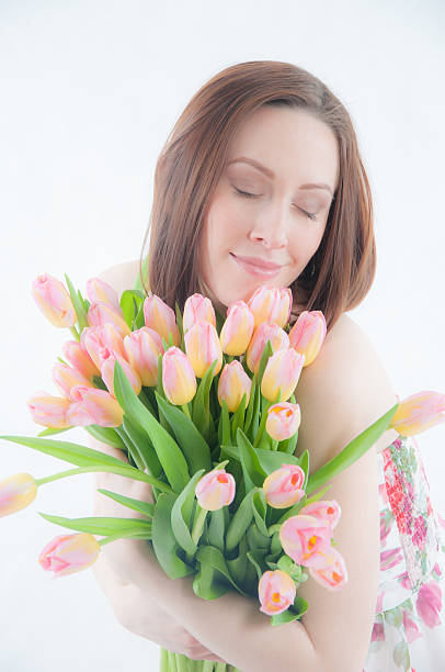 istock Portrait of young woman with tulips 468722708