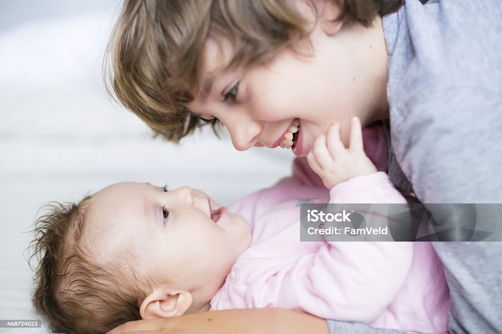 Baby girl laughing to her brother Affectionate Stock Photo