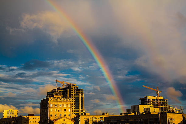Photo of bright colorful rainbow over city stock photo