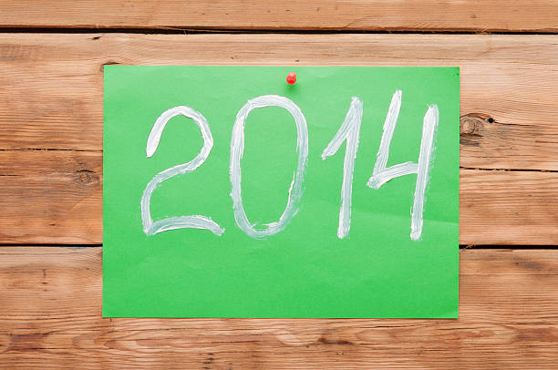 istock Hand writing text  2014 new year on wooden wall. 468726169