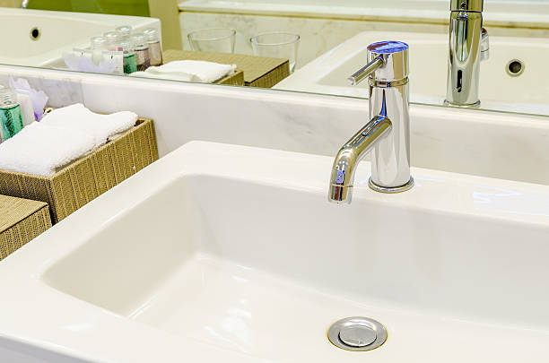 istock White sink and faucet in a bathroom 468726390