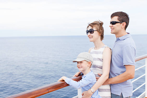Family looking at the sea view during a cruise family of three enjoying vacation at cruise ship passenger ship photos stock pictures, royalty-free photos & images