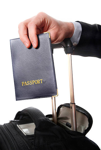 istock business man hand close up holding passport 468729745