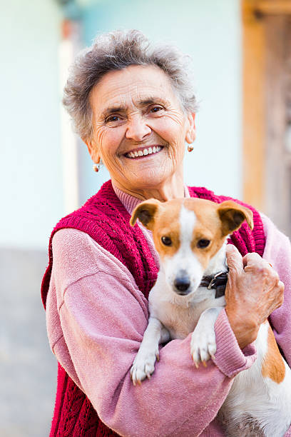 istock Smiling Elderly Woman with Pet 468731143