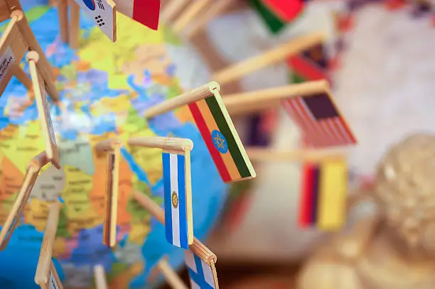 Close-up national flags stuck in the globe