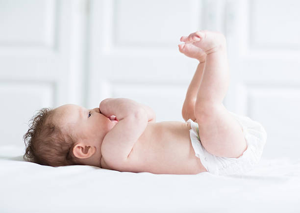 istock Funny little baby playing with its legs 468732011