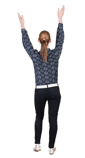 istock Back view Beautiful woman in jeans looking wall and Holds 468732422