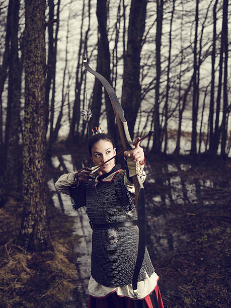 istock Medieval archery, woman shoot 468732698