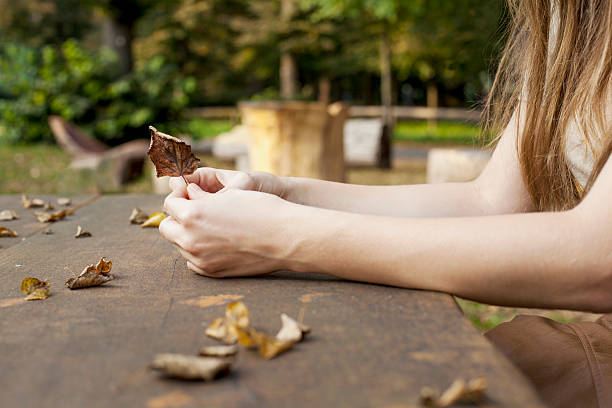 istock Young girl holding dry leaf in her hands 468733004
