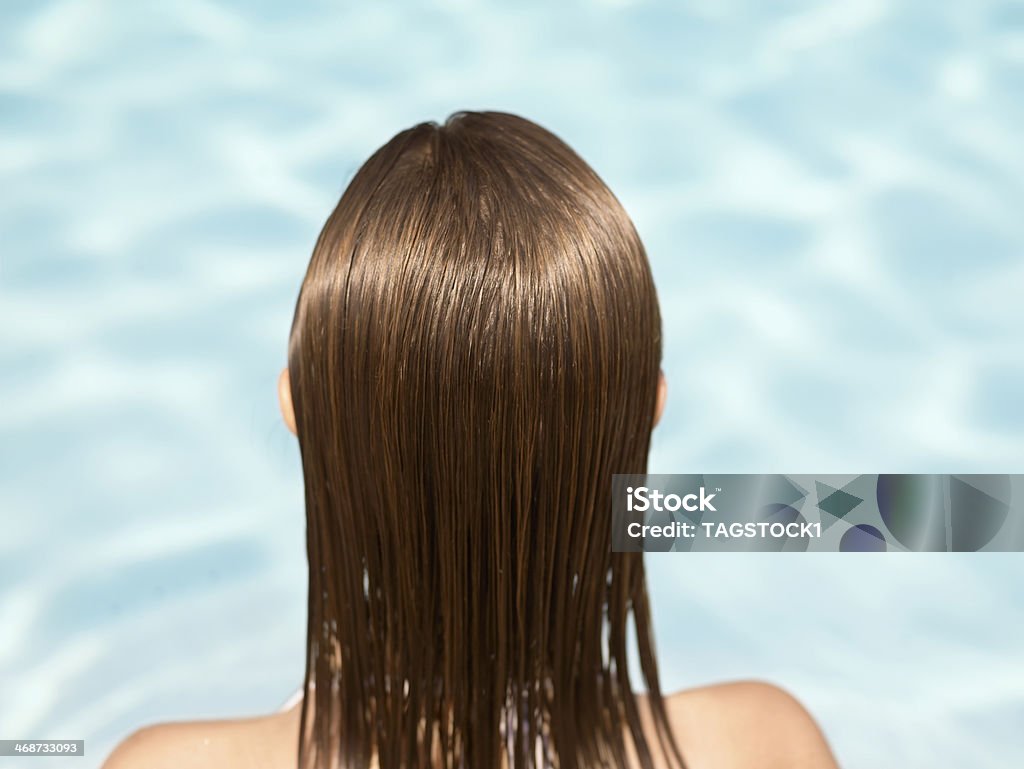 Rear View of Woman in Swimming Pool Wet Hair Stock Photo