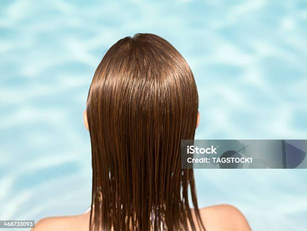 Rear View Of Woman In Swimming Pool Stock Photo - Download Image Now - Wet Hair, Rear View, Swimming Pool