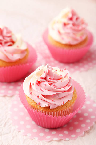 istock Tasty cupcake on pink background 468733562
