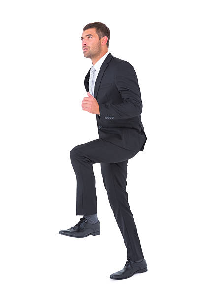 istock Businessman walking with his leg up 468733786