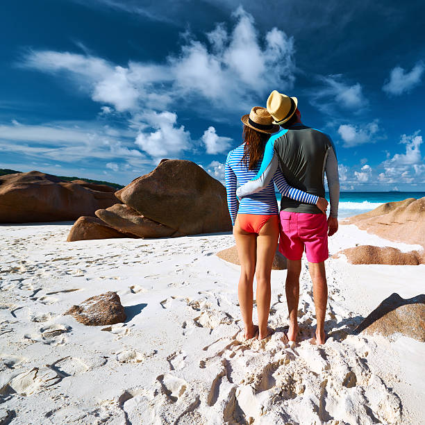 istock Couple at tropical beach wearing rash guard 468734772