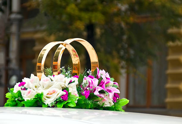 Purple ribbon decoration on wet wedding car