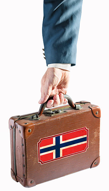 istock Businessman holding antique suitcase Norway flag 468740649