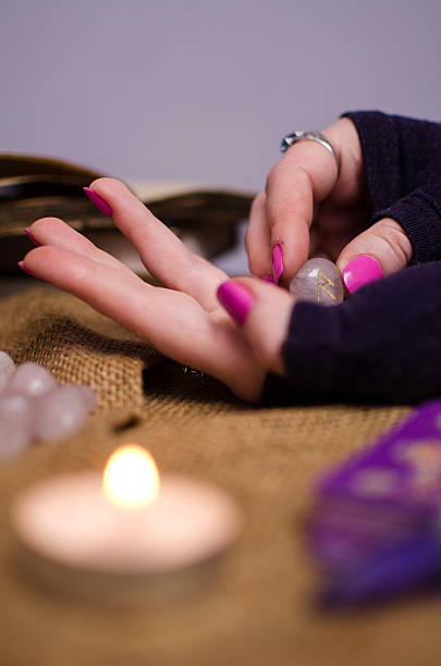 istock female hand holding a magic rune stone 468743570