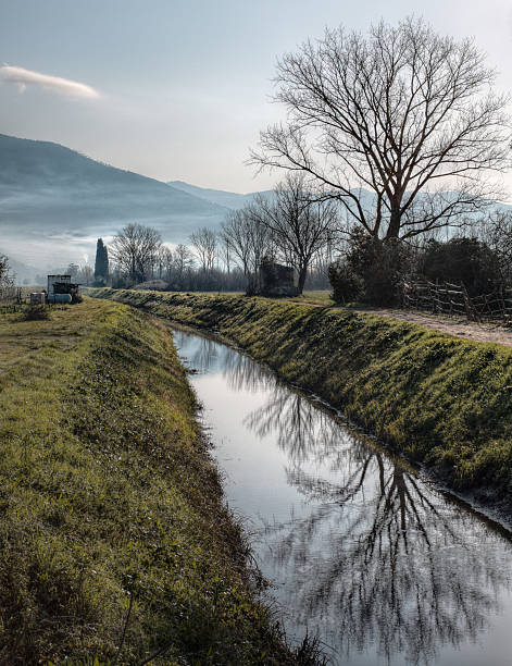 istock Tuscan countryside with water creek 468743948
