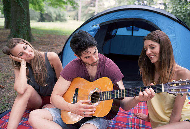 istock Friends play the guitar at the camping 468744148