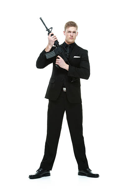istock Businessman holding rifle and looking at camera 468745116