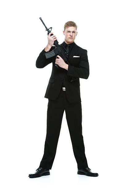 150+ Man In Suit Holding Rifle Stock Photos, Pictures & Royalty-Free ...