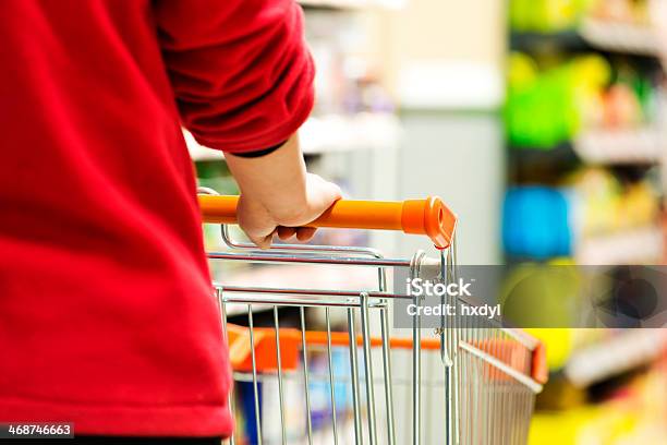 Lady Pushing A Shopping Cart In The Supermarket Stock Photo - Download Image Now - Adult, Adults Only, Aisle