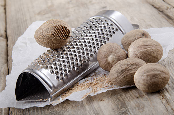 istock grated nutmeg and powder on paper 468750121