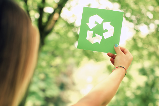 Woman holding a recycle sign