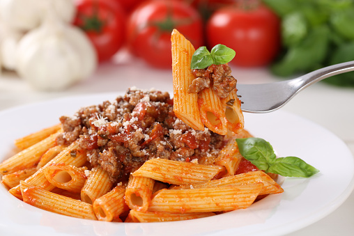 Eating pasta Bolognese or Bolognaise sauce noodles meal on a plate