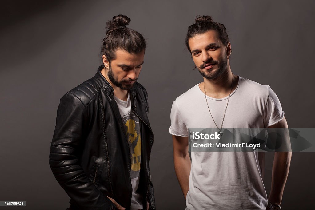 Two Men With Hair Buns And Facial Hair Stock Photo - Download Image Now -  Men, Twin, Long Hair - iStock