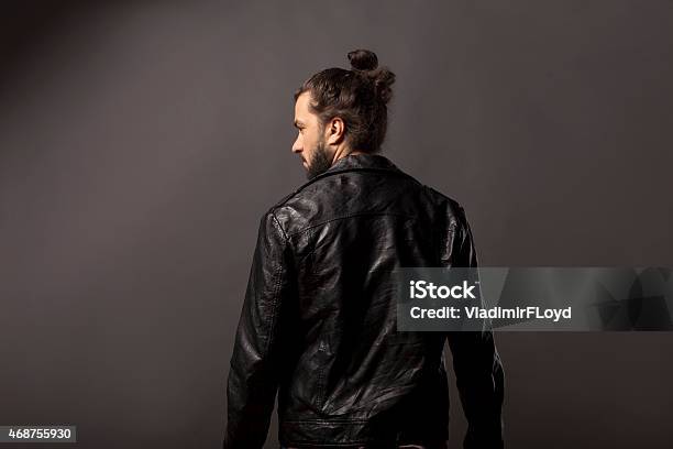 Man With Beard In A Black Leather Jacket Stock Photo - Download Image Now - Man Bun, Rear View, Back